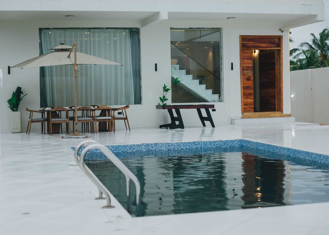The pool, set into a white terrace beside the house